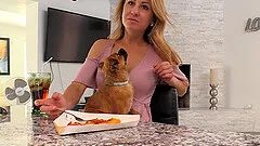 Gorgeous blonde MILF Leah sits at the table in deep cleavage