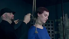 Tall redhead beauty Kitty Dorian strapped to a pole and tortured