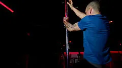 Bald gay stripper dances around the pole and masturbates