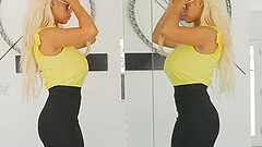 Bridgette strips in front of the mirror and fingers her pussy