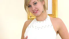 Elegant blonde MILF Holly Anderson strips and masturbates solo