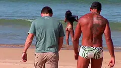 Two guys drill brunette Babalu's pussy on the beach