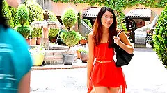 Sweet girl Melody walks around the town while she strips