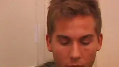 Brock Labelli makes himself at home on the bed, strips naked and starts working up his cock.