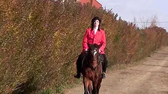 Judi uses a massive sex toy to masturbate in front of a horse