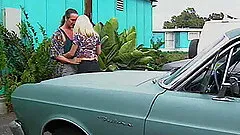 Chick masturbates while watching a blonde being fucked on a car