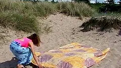 Wavy haired cutie fucks a horny stranger hardcore on the beach