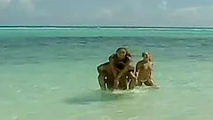 Katy Caro and Lily Love enjoy an erected tool on a beach