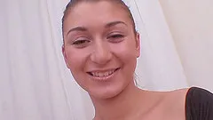 Showing off her attributes before toying with a dildo