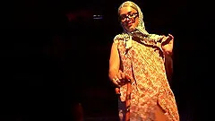 Flexible babe in a sexy striptease and dildo show on public sex fair stage