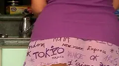 Cute brunette babe plays with a huge toy in a kitchen