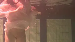 Vintage shoot of solo model brunette swimming seductively