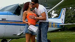 Buxom brunette in glasses has her anal plugged with a fat dong outdoors