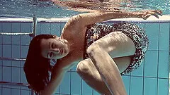 Sexy Sima Lastova reveals her shaved pussy while swimming in the pool