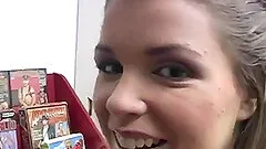 Charming lass giving the big black cock from a gloryhole a superb blowjob