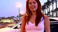 Daring solo model in a lovely dress spreads her legs revealing her pussy in public