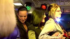 Horny girls go on their knees and blow massive cocks in a crowded club