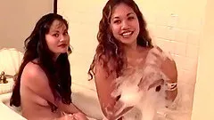 Two exotic beauties get naked and play in a bubble bath