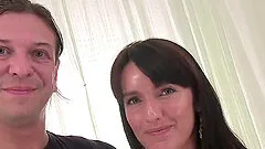 Promesita has long dark hair and a petite frame