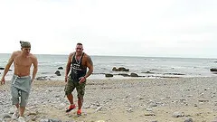 Body builder and a fit girl have athletic sex on the beach