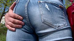 Public blowjob in the park from a redhead in sexy jeans