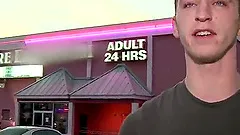 Handsome gay awarding massive dick with blowjob through glory hole