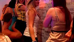 Brunette and blonde sharing a dude's cock and sucking it in a club