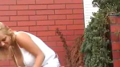 A busty lady with a sexy ass exposing herself outdoor