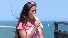 At the beach she trades licking ice cream for licking cock