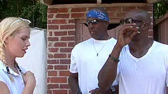 Mini-skirt clad blonde with a hot ass enjoying an interracial gangbang