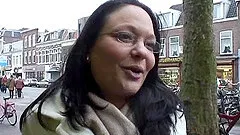 Chubby cougar with glasses playing with a stranger's cock