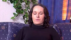 Blazing solo model in a thong stuffs her cunt with a dildo close up