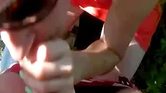 Close up a girl sucking and swallowing out by the lake