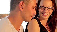 An auburn haired hottie in glasses takes it doggy style