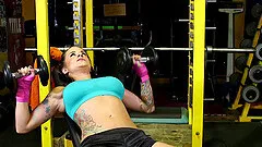 After doing the dumbell press she fucks her pussy with a toy in the gym