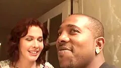 A white cougar gags on a big black cock then gets fucked