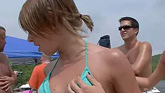 A party girl takes off her bikini at the beach and teases her clit