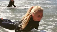 After some surfing four hot, fit babes hook up on the beach