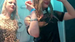 Hot girls kissing and dancing in a shower on a club stage