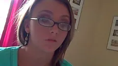 Blondie in glasses giving blowjob in bed in POV