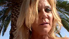 A cougar gets naked outside then gets her shaved pussy pounded