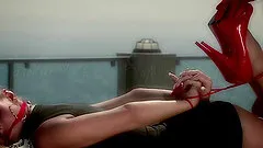 A mistress ties up her chick then fucks her with a toy