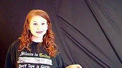 Redhead babe in thong strips and shows natural tits in solo model clip