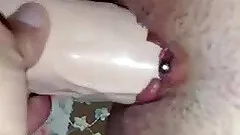 Homemade solo with a chick poking a vibrator in her pierced pussy