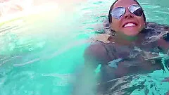 Brunette slut gives head and takes cumshot after riding cock in the pool