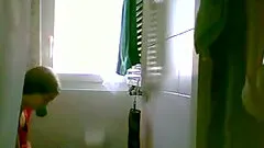 Amateur brunette changes her clothes in a bathroom in homemade reality