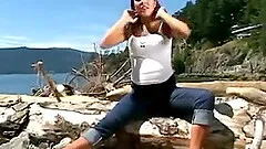A guy films his pregnant wife fisting her pussy on a beach