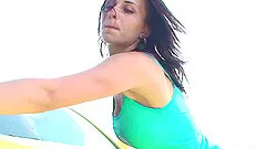 A sexy teen gets naked and wet while outside washing her car