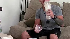 Hot gay guy with short dark hair playing with his cock on his sofa