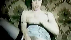 Woman in stockings fucks her cunt with a toy in homemade retro clip